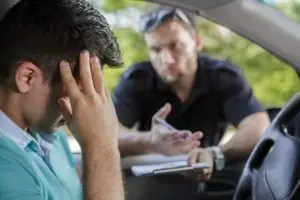 police officer writes ticket for distraught motorist