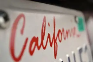 Closeup on a California license plate and registration sticker.