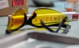 Glasses and a box marked “evidence”