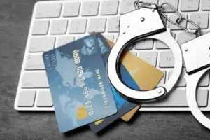 Handcuffs and credit cards on a computer keyboard