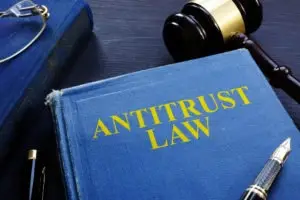 a book about antitrust law on a desk beside a gavel