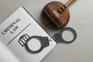 a gavel handcuffs and a criminal law book