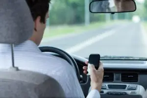 a man using his cellphone while driving