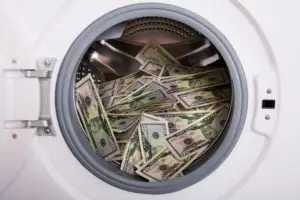 a washing machine filled with fifty dollar bills