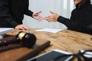 lawyer shakes hands with client