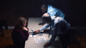 detectives interrogating a woman