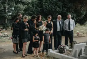 large family grieves at loved one’s grave