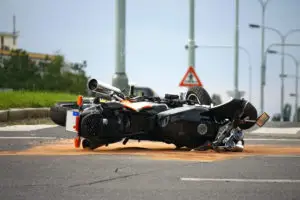 a motorcycle lying on its side in the road