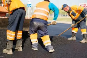 construction workers asphalting a road