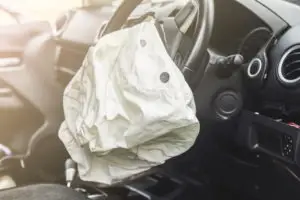 interior of a car after the steering wheel airbag deployed