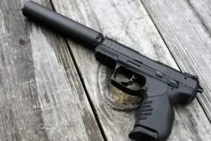 a handgun with a silencer attached