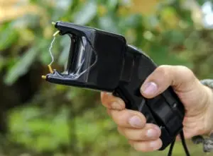 a person holding a stun gun