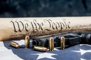 handgun bullets and constitution on american flag