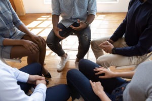 people sitting in a circle at a drug rehab program