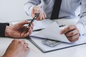 a businessman revealing a cash bribe in the middle of a contract