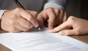 a man is directed where to sign a document