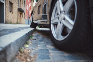 car with one wheel on sidewalk