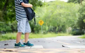 child waits in roadway safety zone