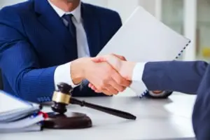 lawyer shakes his clients hand