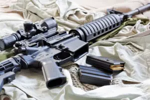 an ar 15 rifle with magazines and ammo