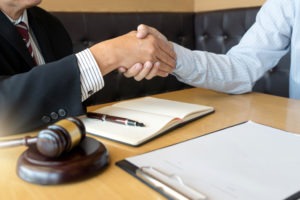 defendant shaking hands with his lawyer