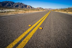 double yellow lines down the middle of a highway road