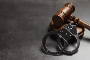 gavel and cuffs on plain background
