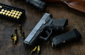 gun and bullets on a desk