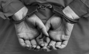 black-and-white-handcuffs-on-hands