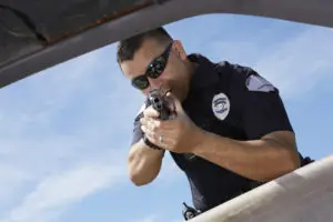 male police officer aiming gun