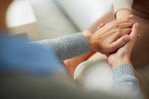 psychiatrist holding patient’s hand