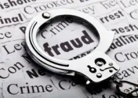 fraud definition highlighted with handcuffs