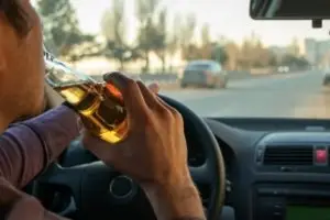 man drinking behind the wheel