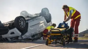 paramedic helping car accident victim
