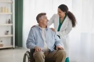 senior man in wheelchair with nurse