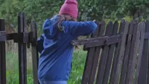 woman breaking into someone’s fence