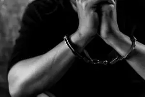 black and white picture of man in handcuffs