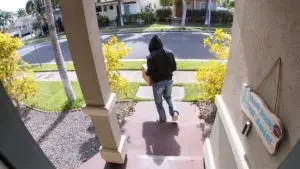 man stealing package from front step