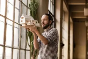 male architect looking over model