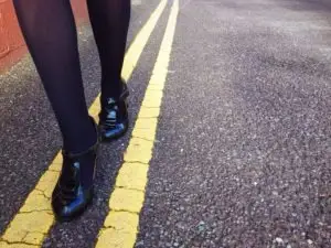 woman walking on yellow street lines for sobriety
