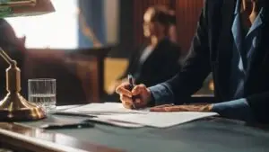 man filling out paperwork in court