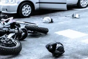 helmet and motorcycle on street after crash
