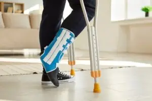 man walking on crutches