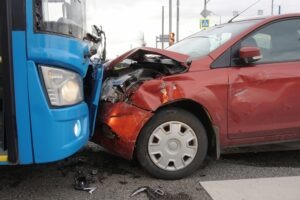 bus and red car in crash