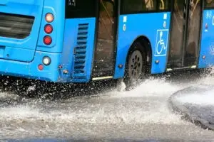 bus speeding through a puddle