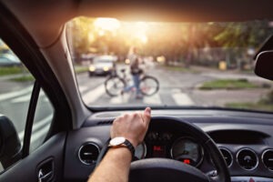 driver waiting for cyclist to pass