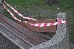 red white emergency tape on broken bench