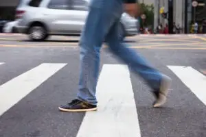 man crossing pedestrian lane blurred