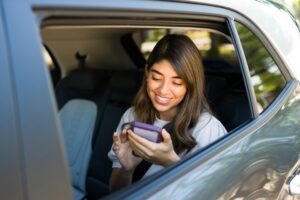 woman on her phone in rideshare car