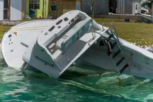 partially sunk boat by coastline